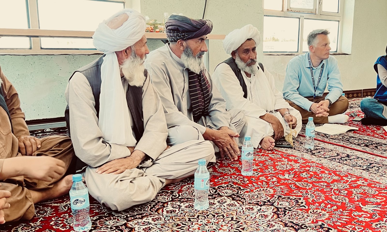George Willcoxon seated with community elders during a consultation in Herat, Afghanistan